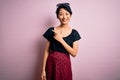 Young beautiful asian girl wearing casual dress standing over isolated pink background cheerful with a smile on face pointing with Royalty Free Stock Photo