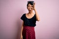 Young beautiful asian girl wearing casual dress standing over isolated pink background doing ok gesture shocked with surprised Royalty Free Stock Photo