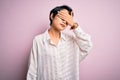 Young beautiful asian girl wearing casual shirt standing over isolated pink background covering eyes with hand, looking serious Royalty Free Stock Photo
