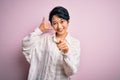 Young beautiful asian girl wearing casual shirt standing over isolated pink background smiling doing talking on the telephone Royalty Free Stock Photo