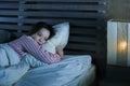 Young beautiful Asian Korean girl lying on bed late night awake looking thoughtful suffering insomnia sleeping disorder feeling Royalty Free Stock Photo