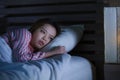 Young beautiful Asian Korean girl lying on bed late night awake looking thoughtful suffering insomnia sleeping disorder feeling Royalty Free Stock Photo