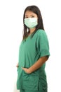 Young beautiful Asian Korean medicine doctor woman or hospital nurse in scrubs using protective medical face mask in prevention