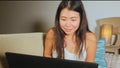 Young beautiful Asian Korean student girl happy and relaxed at home sofa couch using internet on laptop computer networking cheerf Royalty Free Stock Photo