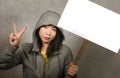 Young beautiful Asian Korean student woman as protestor and pacifist holding protest billboard with blank copy space standing