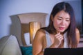 Young beautiful Asian Korean student woman happy and relaxed at home sofa couch using internet on laptop computer networking cheer Royalty Free Stock Photo