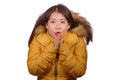 Young beautiful Asian Korean woman feeling cold and chilly freezing feeling cold in Winter weather wearing yellow jacket with fur Royalty Free Stock Photo