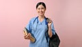 Young beautiful Asian medical student smiling to the camera while holding a bag and books Royalty Free Stock Photo