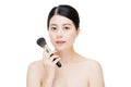 Young beautiful asian model makeup foundation being brushed on f Royalty Free Stock Photo