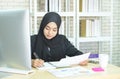 Young woman muslim work in office using phone