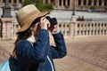 Young and beautiful asian tourist taking photos of monument with reflex camera during her vacation trip Royalty Free Stock Photo