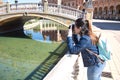 Young and beautiful asian tourist taking photos of monuments with reflex camera leaning on a railing during her vacation trip Royalty Free Stock Photo