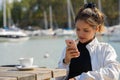 Young beautiful Asian tourist woman at restaurant by the pier Royalty Free Stock Photo