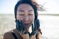 Young beautiful asian woman applying a black cosmetic mask for the face of the therapeutic black mud. Spa treatment and face beaut Royalty Free Stock Photo