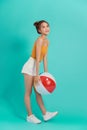 Young beautiful Asian woman with beach accessories holding colorful ball in bright background Royalty Free Stock Photo