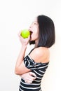 Young beautiful asian woman biting green apple profile Royalty Free Stock Photo