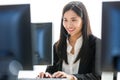 Young and beautiful Asian woman call center officer wearing microphone headset and happy working with a friendly face and positive Royalty Free Stock Photo