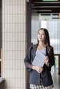 Young beautiful asian woman in casual clothes sits in chair using laptop computer Royalty Free Stock Photo