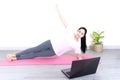 Young beautiful asian woman doing training fitness workout sport exercise feel no stress free, using laptop while sitting on floor Royalty Free Stock Photo