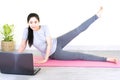 Young beautiful asian woman doing training fitness workout sport exercise feel no stress free, using laptop while sitting on floor Royalty Free Stock Photo