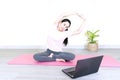 Young beautiful asian woman doing training fitness workout sport exercise feel no stress free, using laptop while sitting on floor Royalty Free Stock Photo