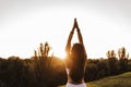 young beautiful asian woman doing yoga in a park at sunset. Yoga and healthy lifestyle concept Royalty Free Stock Photo