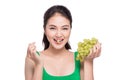 Young beautiful asian woman eating fresh grapes isolated on whit Royalty Free Stock Photo