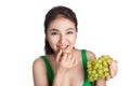 Young beautiful asian woman eating fresh grapes isolated on whit Royalty Free Stock Photo