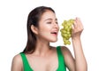 Young beautiful asian woman eating fresh grapes isolated on whit Royalty Free Stock Photo