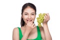 Young beautiful asian woman eating fresh grapes isolated on whit Royalty Free Stock Photo