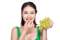 Young beautiful asian woman eating fresh grapes isolated on whit Royalty Free Stock Photo