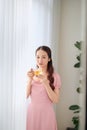 Young beautiful Asian woman eating pill and drinking water Royalty Free Stock Photo