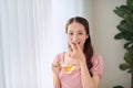 Young beautiful Asian woman eating pill and drinking water Royalty Free Stock Photo