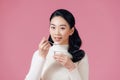Young beautiful asian woman eating yogurt with spoon looking satisfied healthy lifestyle isolated pink background Royalty Free Stock Photo