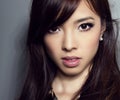 Young beautiful asian woman with flawless skin and perfect make-up and brown hair