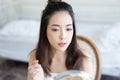 Young beautiful Asian woman with fresh Healthy Skin  looking at herself in mirror.Natural Makeup Touching Face. Cosmetic Concept Royalty Free Stock Photo