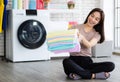 Young and beautiful Asian woman happy with chore and holding stack of clean and good smell towel chothes Royalty Free Stock Photo