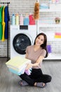 Young and beautiful Asian woman happy with chore and holding stack of clean and good smell towel chothes Royalty Free Stock Photo