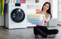 Young and beautiful Asian woman happy with chore and holding stack of clean and good smell towel chothes Royalty Free Stock Photo