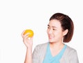 Young beautiful asian woman holding orange and smiling, health care concept.