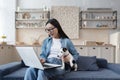 Young beautiful asian woman in kitchen teenager uses laptop student girl studies at home Royalty Free Stock Photo