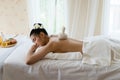 Young beautiful Asian woman relaxing in the spa massage Royalty Free Stock Photo