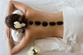 Young beautiful Asian woman relaxing in the Spa Stone Massage. S Royalty Free Stock Photo