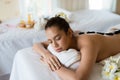 Young beautiful Asian woman relaxing in the Spa Stone Massage. S Royalty Free Stock Photo