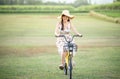 Young beautiful Asian woman riding a bicycle in a park. Active people. Pretty young woman riding bike in a country road Royalty Free Stock Photo