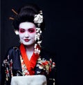 Geisha in kimono on black