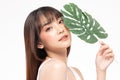 Young Beautiful Asian woman smile with clean and fresh skin with green leaf