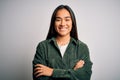 Young beautiful asian woman wearing casual shirt standing over isolated white background happy face smiling with crossed arms Royalty Free Stock Photo