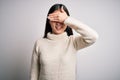 Young beautiful asian woman wearing casual sweater standing over isolated background smiling and laughing with hand on face Royalty Free Stock Photo