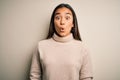 Young beautiful asian woman wearing casual turtleneck sweater over white background afraid and shocked with surprise expression, Royalty Free Stock Photo